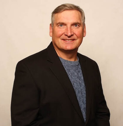 Portrait of Dr. Doug Lobay smiling, wearing a dark blazer
